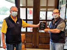 Jerry Colbert (left) receives the 2020 QCMGA Volunteer of the Year Award from outgoing president Shel Zatkin.