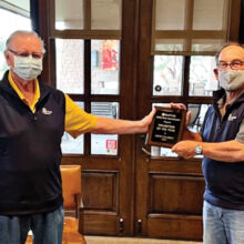 Jerry Colbert (left) receives the 2020 QCMGA Volunteer of the Year Award from outgoing president Shel Zatkin.