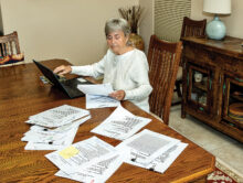 Screening team member Marilyn Burkstrand reviews applications, both online and in hard copy, to make her recommendation for which women should be scheduled for an interview. (Photo by Jim Burkstrand)
