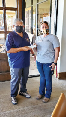 Rene Gill, QCVGA president, presents a check to TROT development director, Margaux DeConcini.