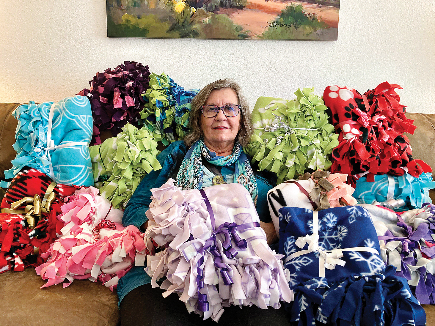 Laura Colbert is surrounded by some of the blankets she made for Women Warriors at Christmas time. (Photo by Jerry Colbert)