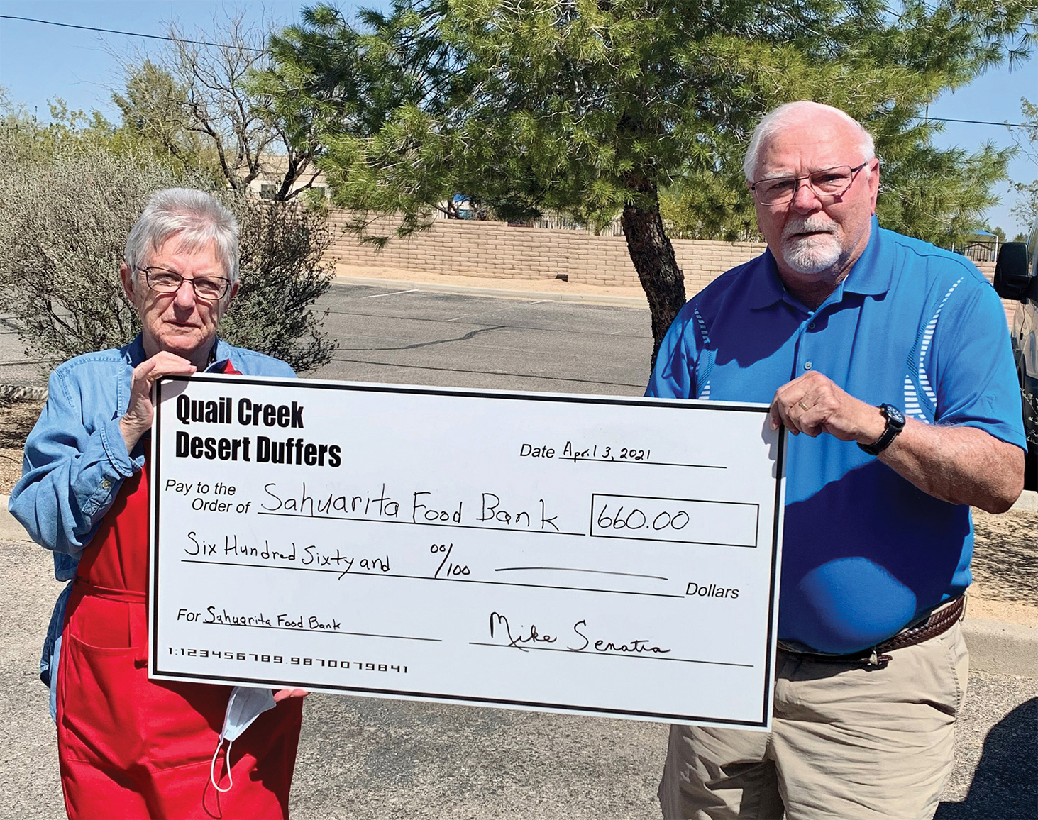Desert Duffer President Mike Senatra presents a check for $660 to Sue Eaton, Assistant Director at the Sahuarita Food Bank